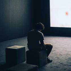 A man sitting in front of a screen