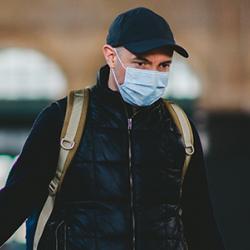 Man wearing face covering to protect against COVID-19
