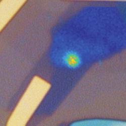 Microscope image of a quantum LED device showing bright quantum emitter generating a stream of single photons. 
