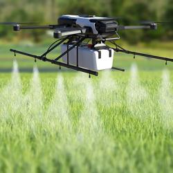 Drone spraying pesticide on wheat field