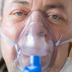 A man with a respirator on his face