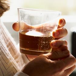 Woman holding a glass of whisky