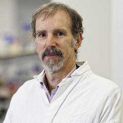 Professor Michele Vendruscolo wearing a white lab coat