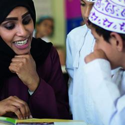 School pupils in Oman reading with their teacher. Image: Cambridge Partnership for Education