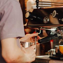 Person using an espresso machine