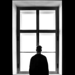 Man standing in front of window