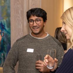 Three researchers at the University of Cambridge in conversation at an event celebrating colleagues for their positive contribution to research culture