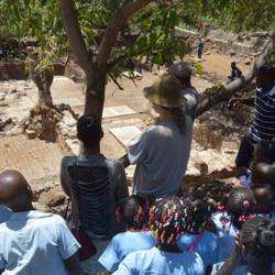 Christopher Evans of the Cambridge Archaeological Unit shows local schoolchildren around the excavation site. 