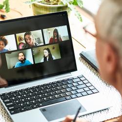 Woman using laptop for team meeting 