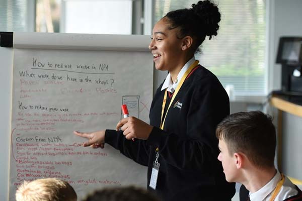 Two students taking part in a waste reduction exercise