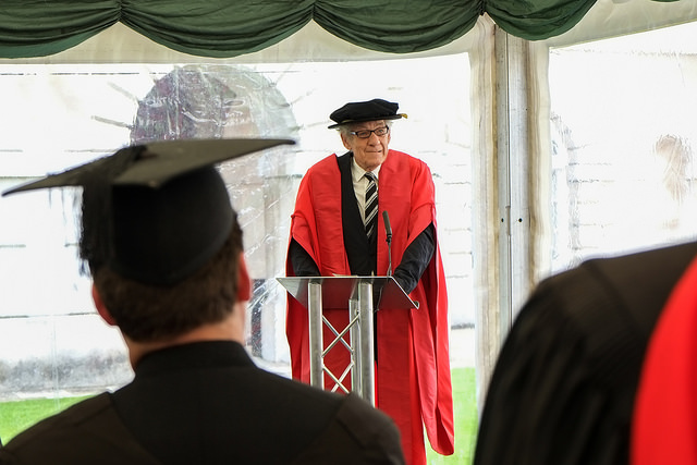 Graduate giving speech in Senate Yard.