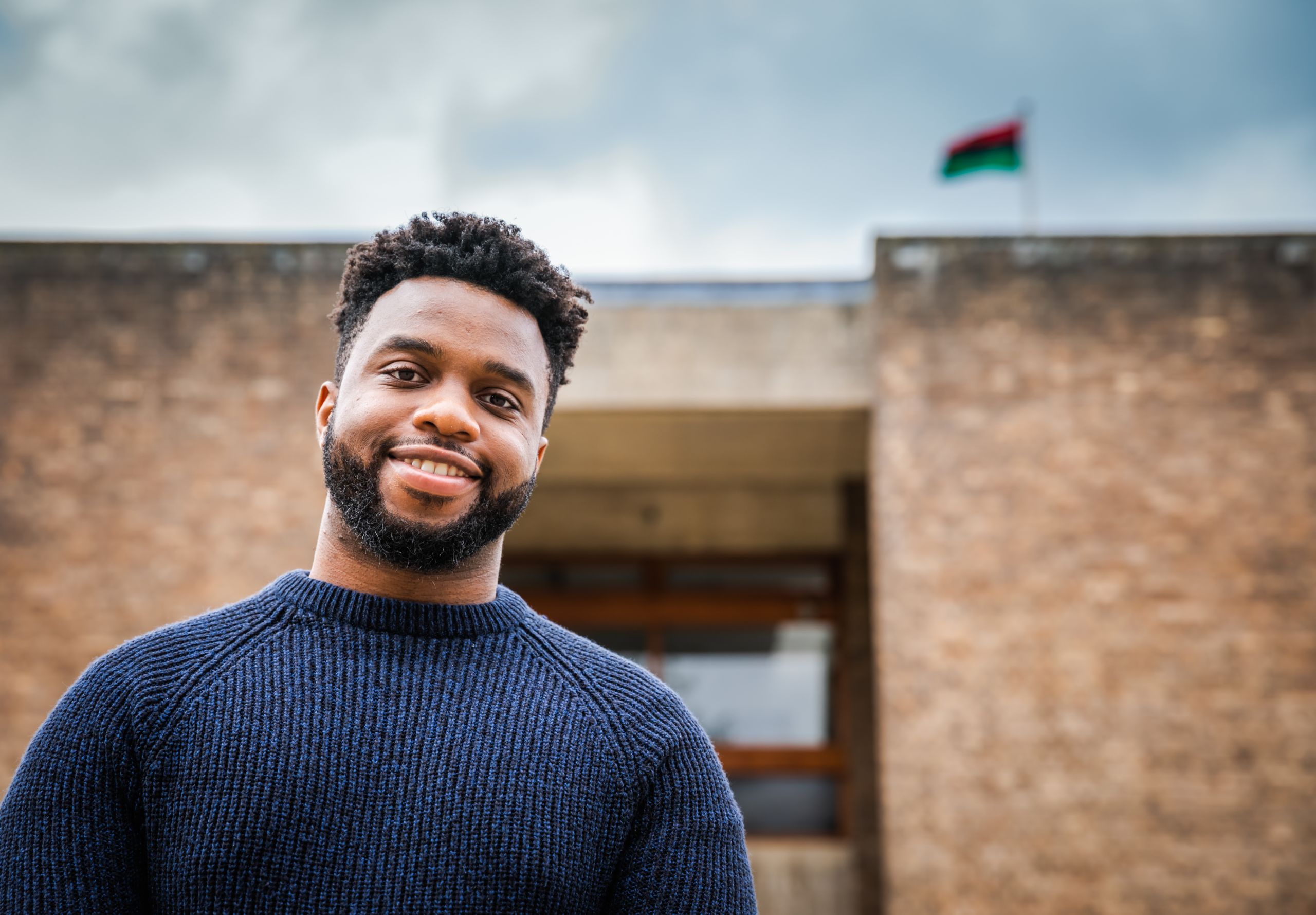 Osarenkhoe with the pan-African flag    