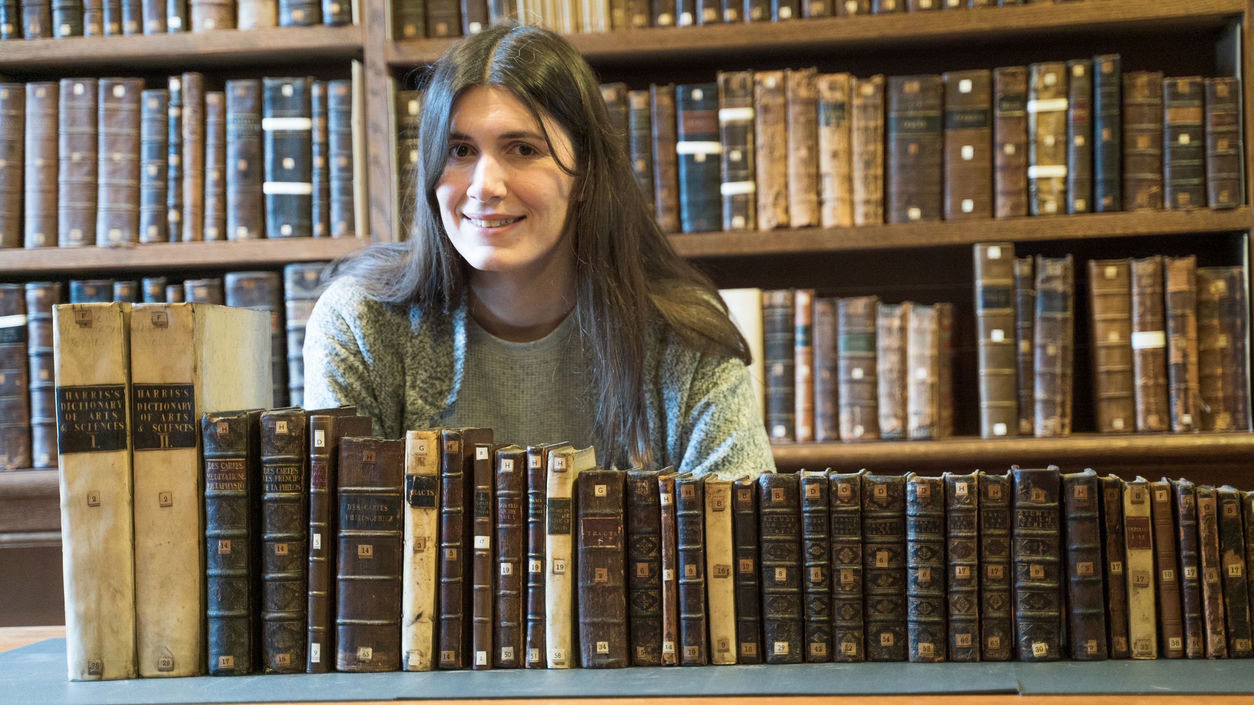 Catherine Sutherland with the Mary Astell Collection in the Old Library, Magdalene College, Cambridge