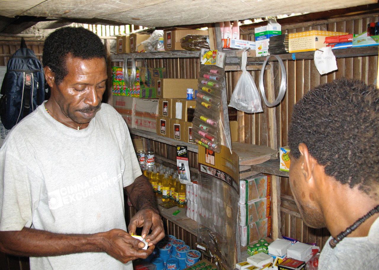 Fenelun Malonggai selling fishing tackle from his family’s store, Yaniruma village