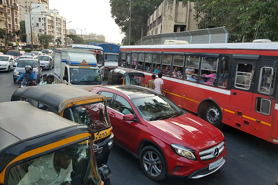 Men crossing a busy street in Mumbai, India. Credit: James Woodcock