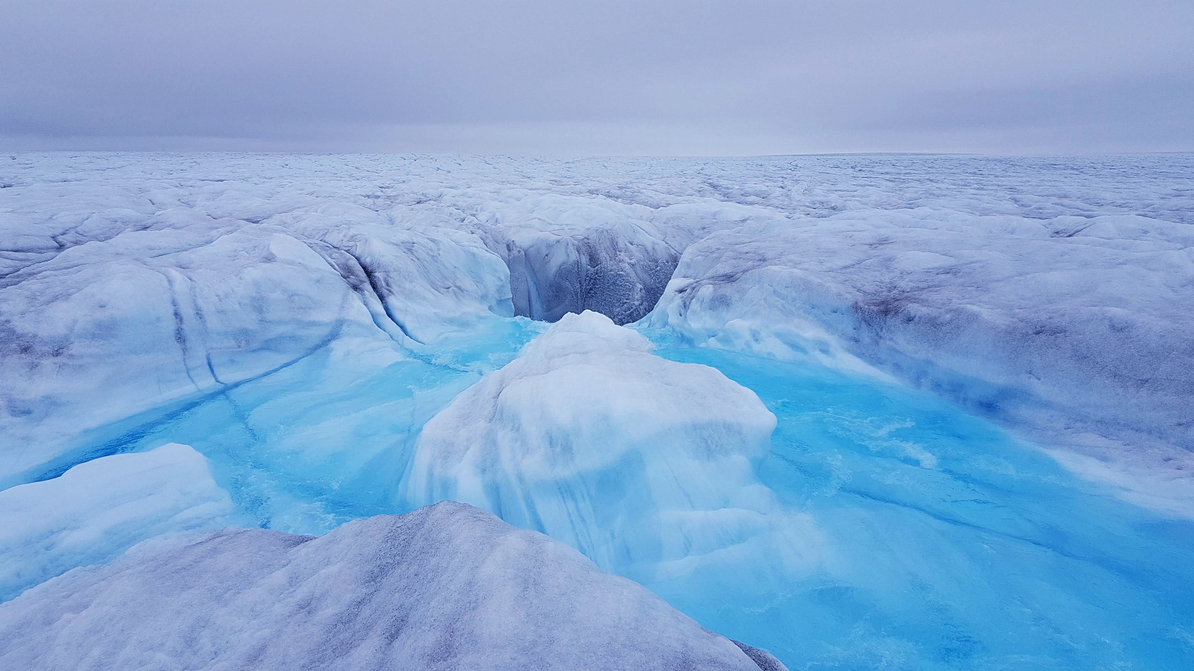 Water flowing into a moulin and to the bed of Store Glacier. Credit: Poul Christoffersen