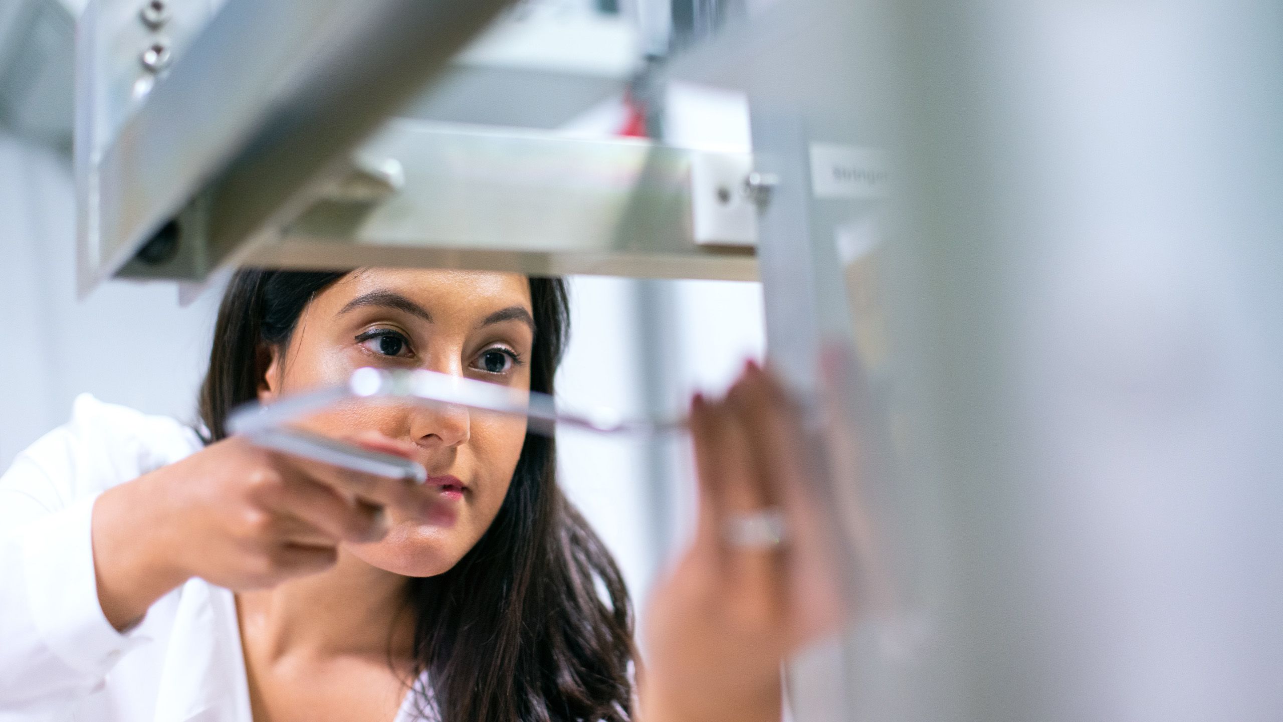 Female operations engineer maintains equipment