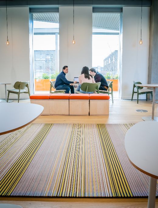 Three people talking around a table
