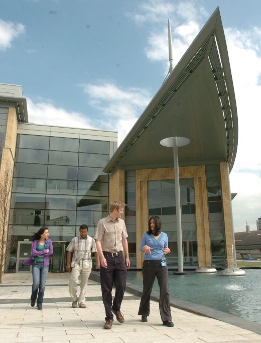 Graduates walking together outside a department