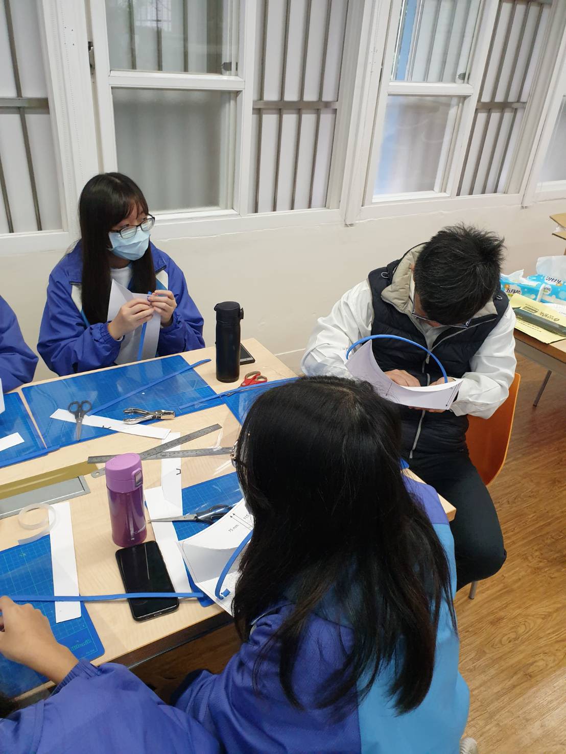 A group of students make face shields 