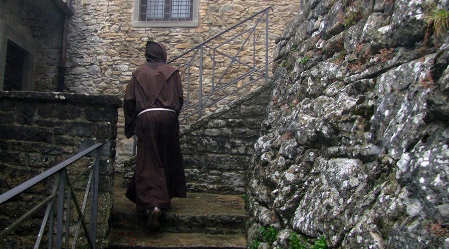 Franciscan monk walking up a stairway