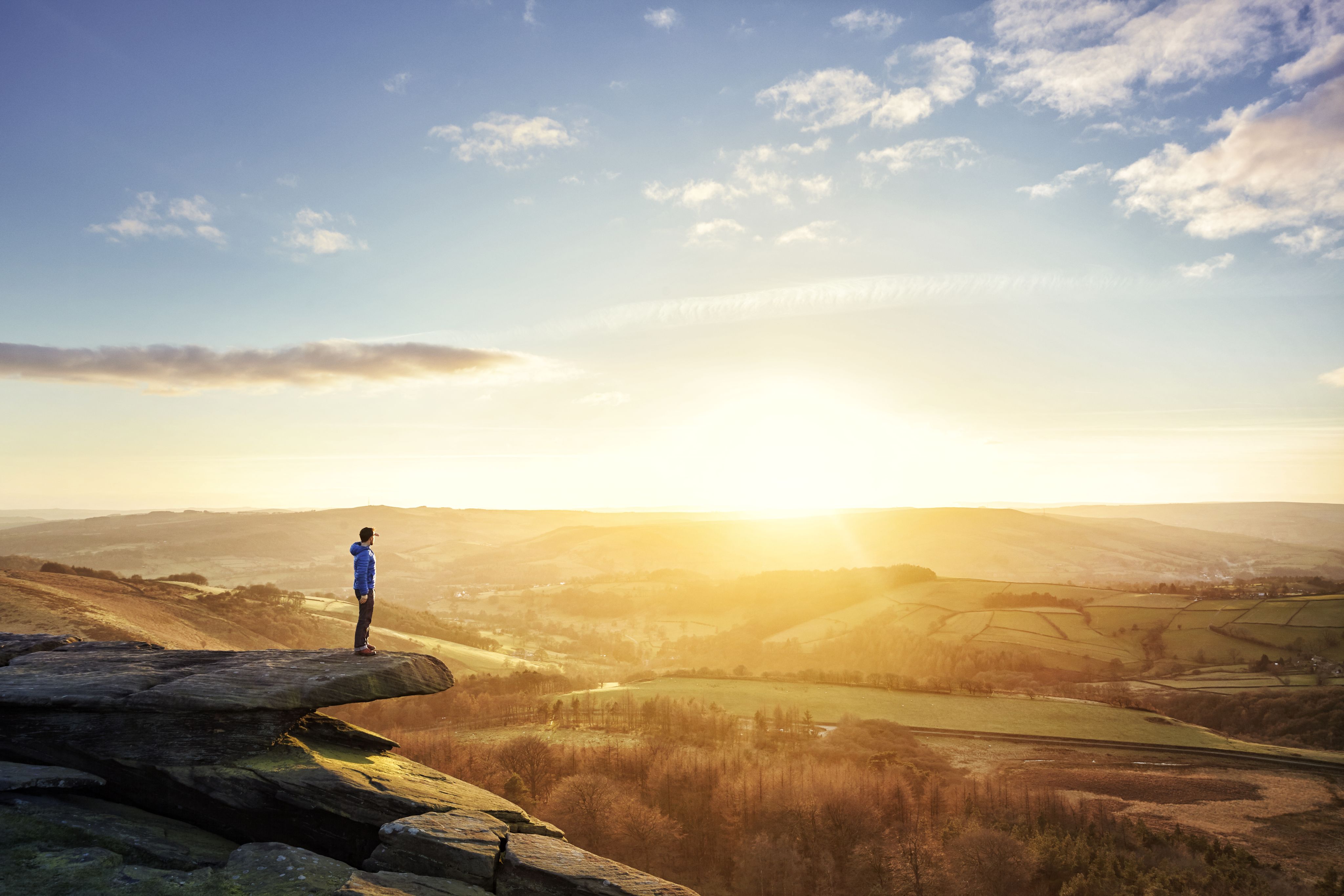 Person standing on hill and looking out over landscape