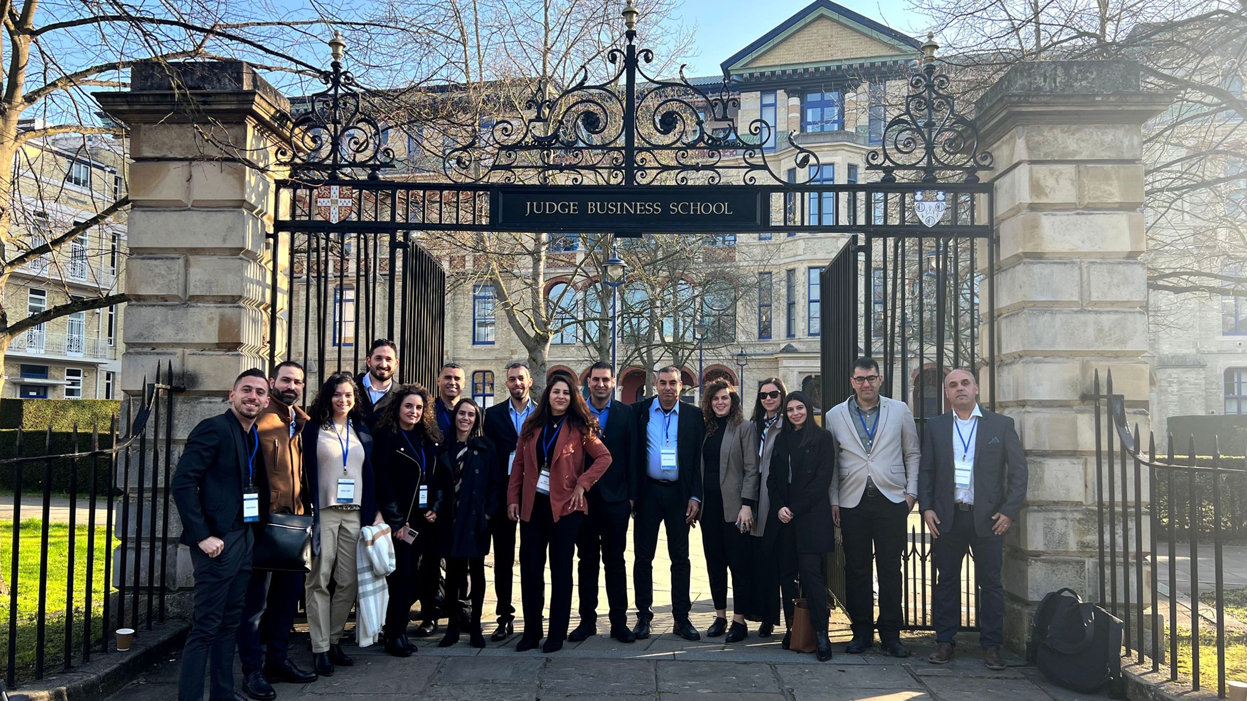 A group of Arab Israeli business students standing in front of Cambridge Judge Business School