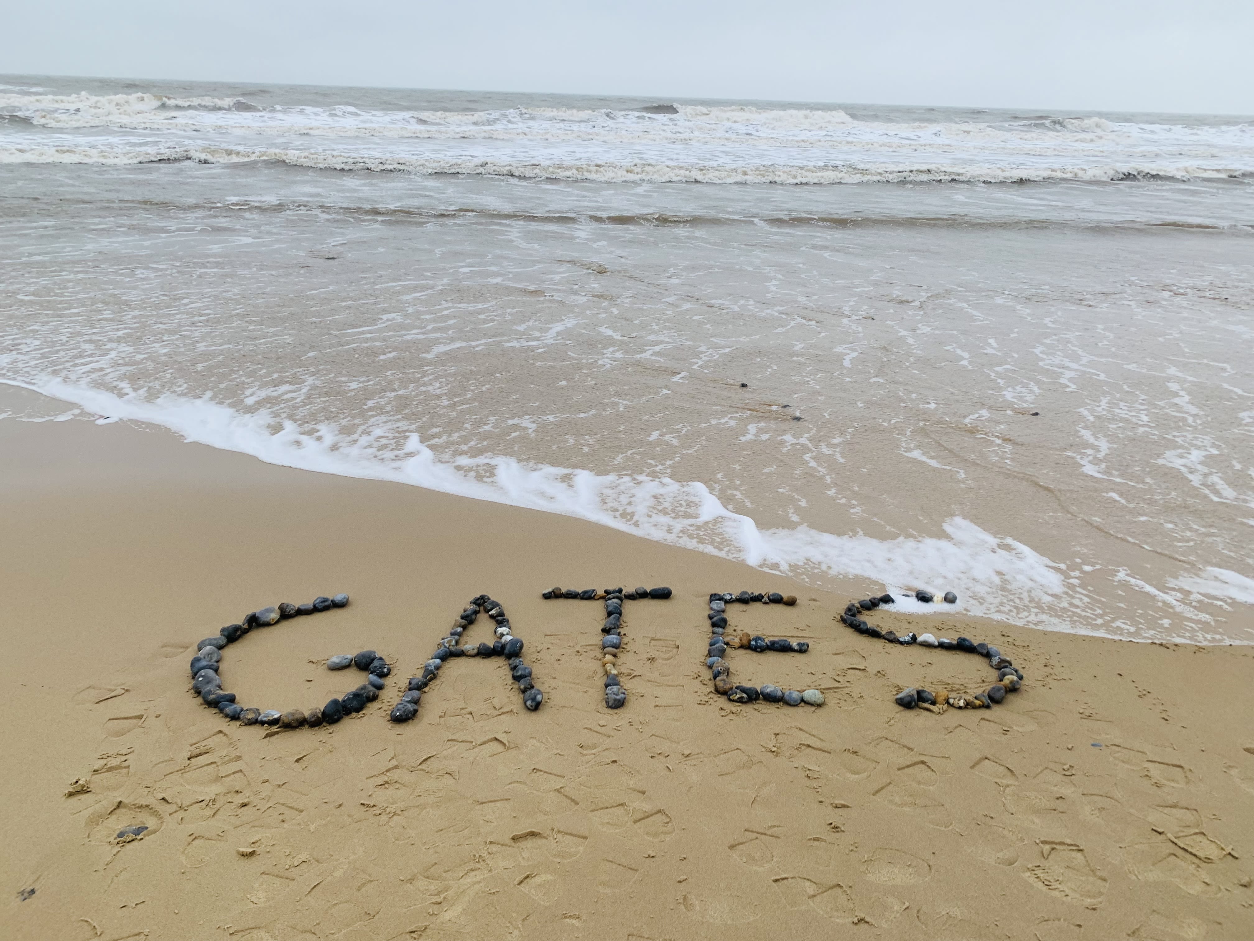 Gates written in stones on beach