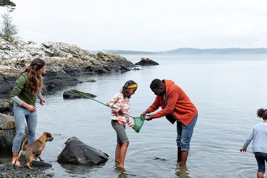 Family with fishing net at seaside