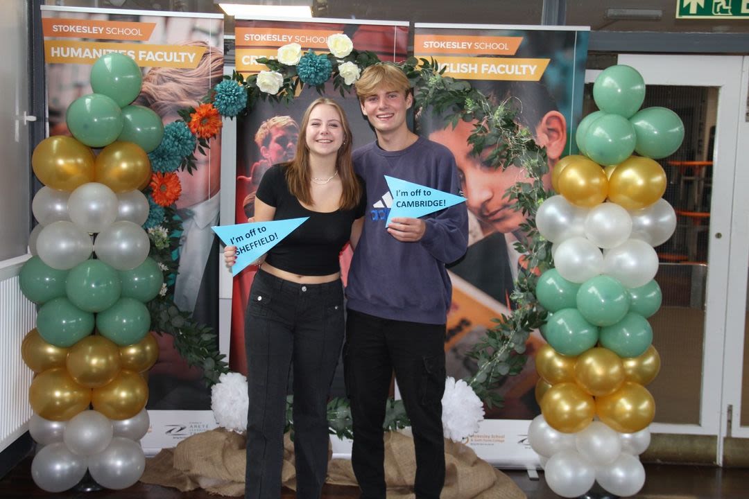 Wilf Vall poses with a classmate in front of balloons