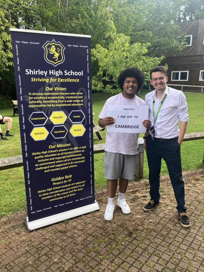 Daanyaal poses for a photo with his results and teacher
