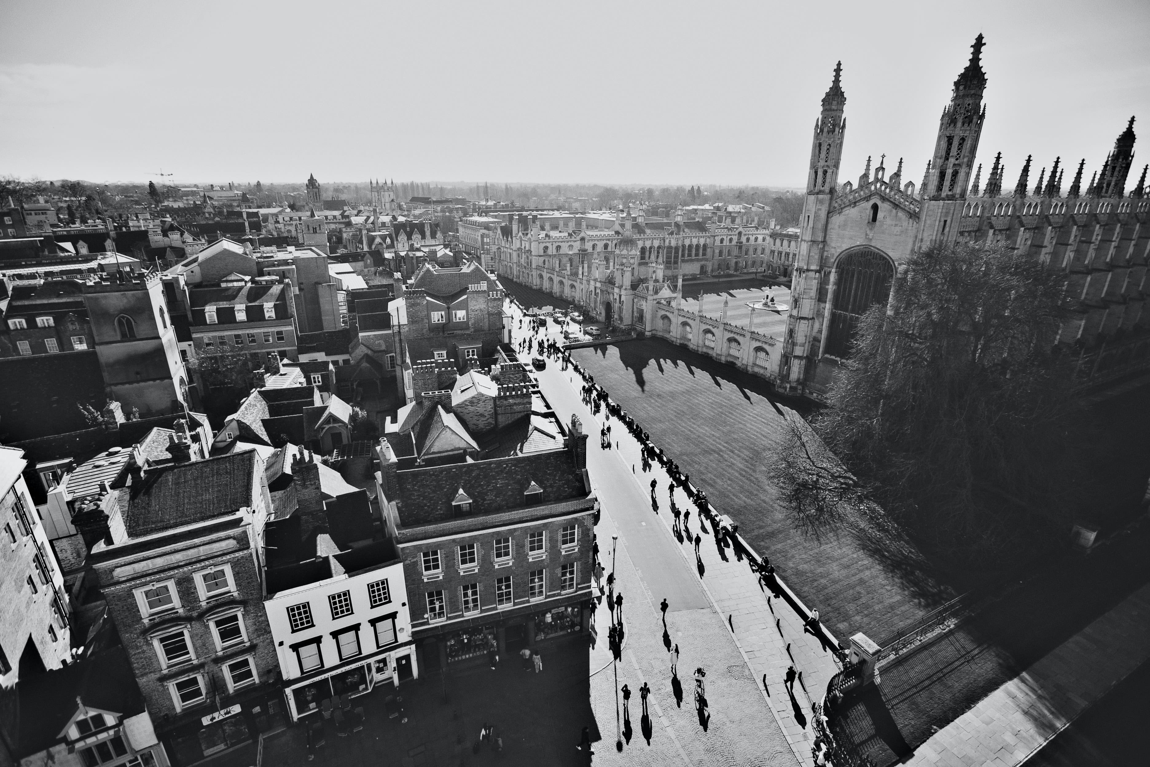 grayscale photo of people walking on street in cambridge