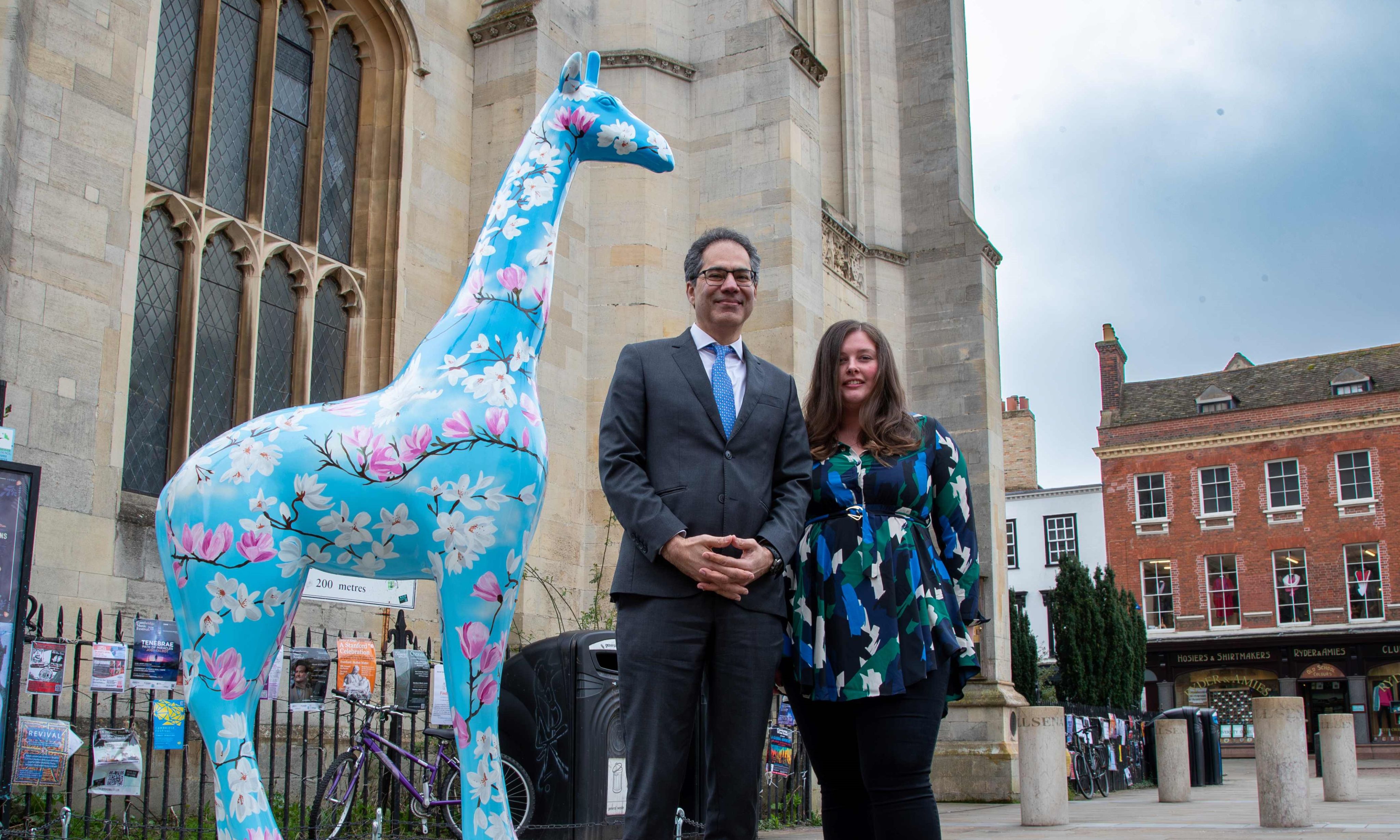 Professor Kamal Munir with artist Charlie Stafford, and giraffe sculpture Growth