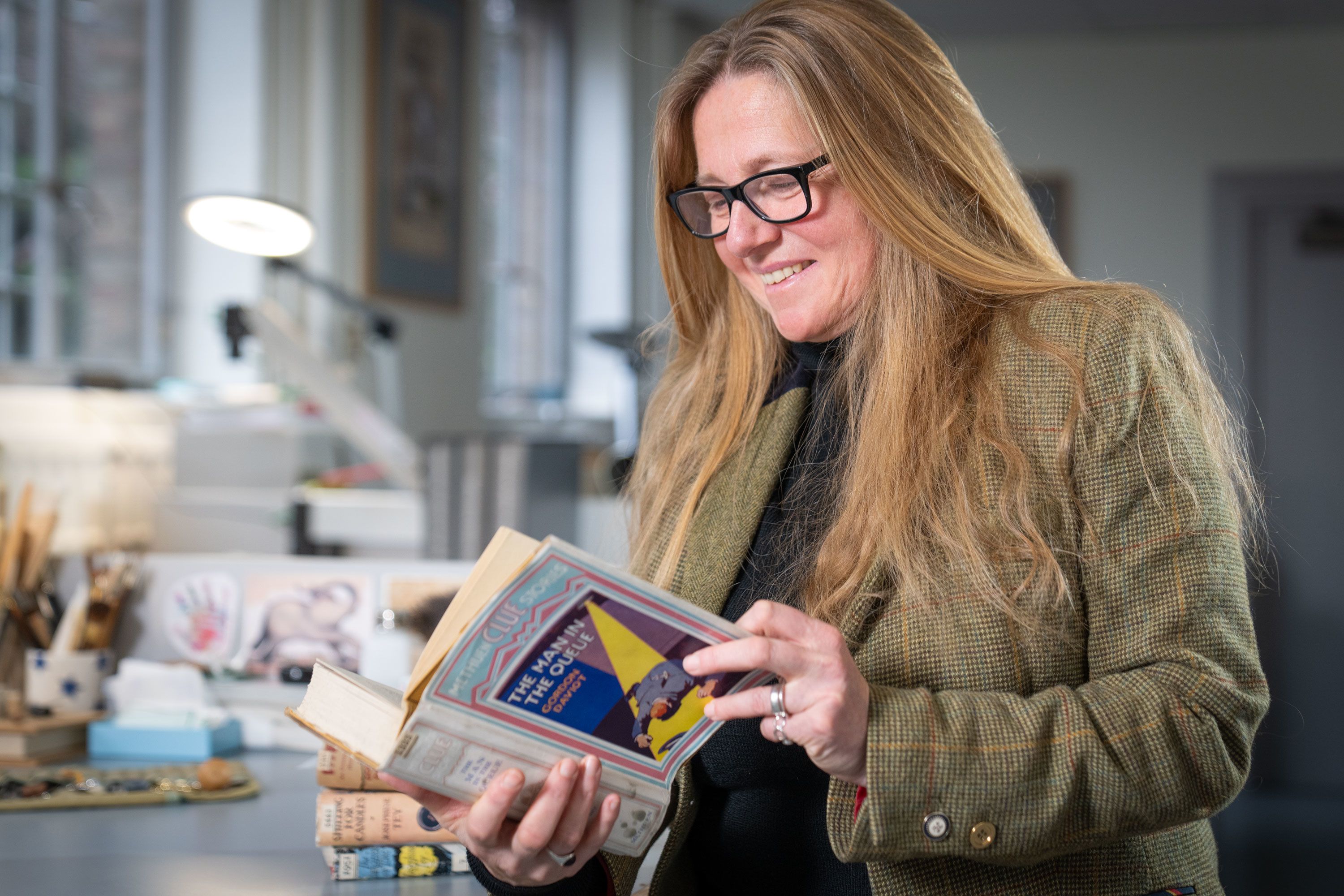 Exhibition curator Nicola Upson with one of the crime novels going on display at Cambridge.