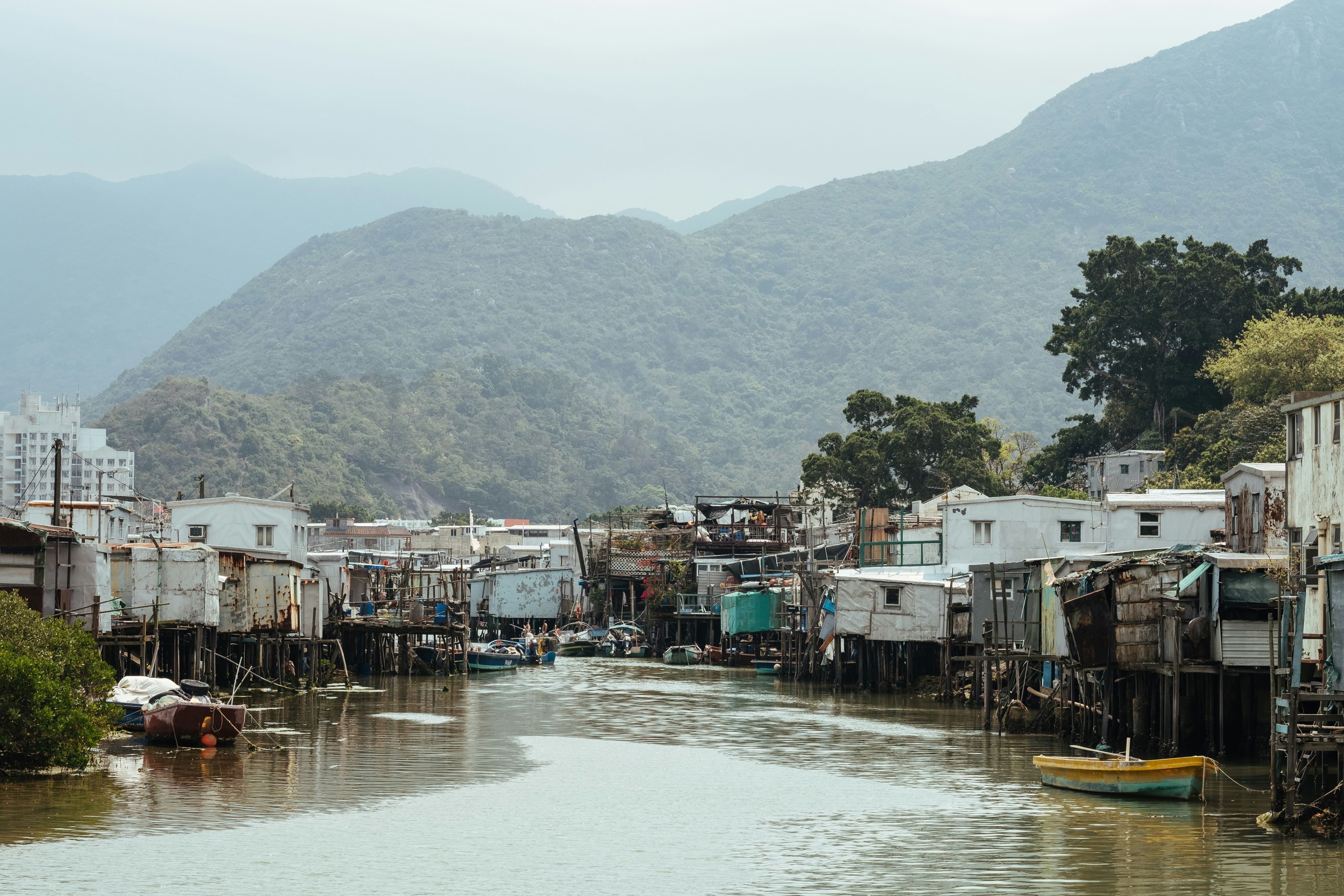 wooden shanties along the riverbank