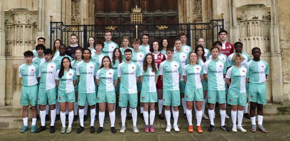 Cambridge football men's and women's team combined stand together