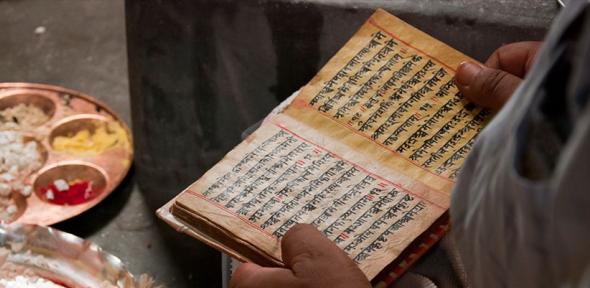 Priest reading Hindu scripts
