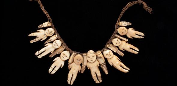 Human-shaped figures and pendants of whale ivory strung on fine plaited coir cords. Probably presented to Lady Gordon, 1875-80, Fiji. 