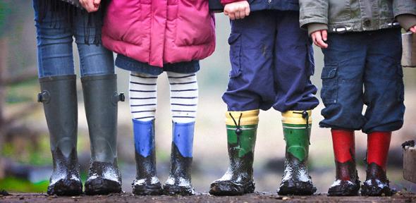 Children outdoors in muddy wellies