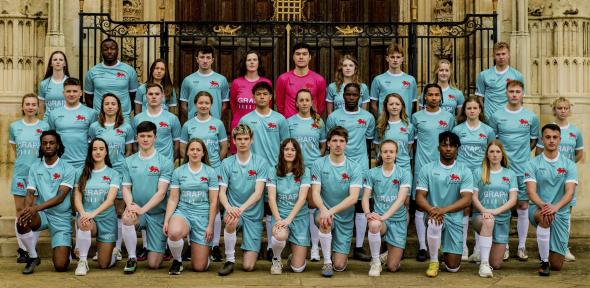 A group of student footballers wearing University of Cambridge kit