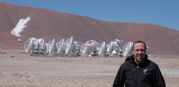 John, in front of the 12-metre-diameter antennas at the ALMA Array Operations Site