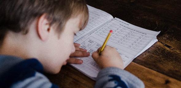 Young boy completes homework