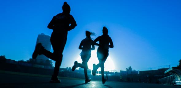 Silhouettes of three women running