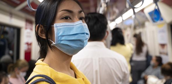 Woman wearing a mask on public transport