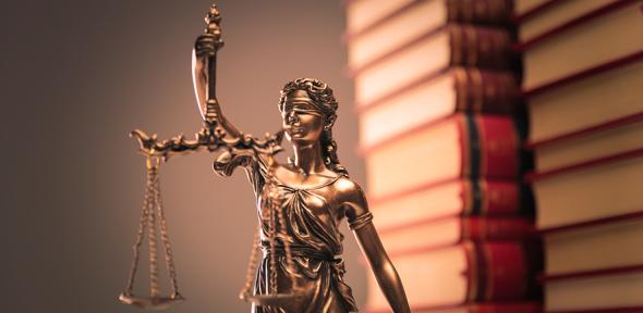 Law books and justice statue