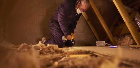 Man installing loft insulation