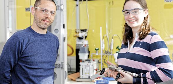Two smiling scientists in a lab