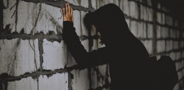 Teenager leaning on a wall