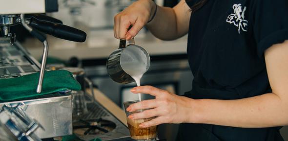 A barista making a coffee