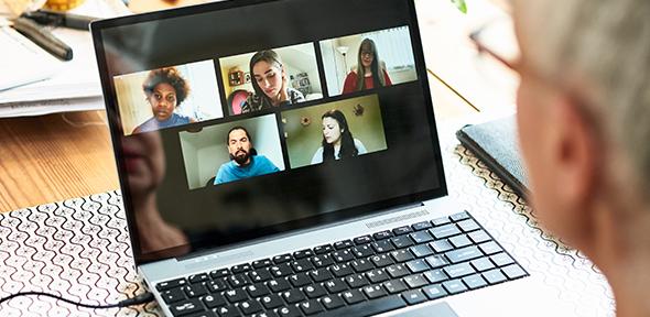 Woman using laptop for team meeting 